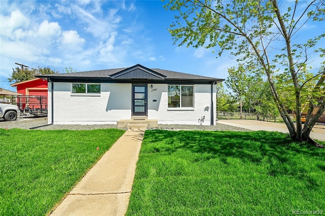 7634 Navajo St, Denver, CO 80221 - view of front of house with a front lawn and brick siding