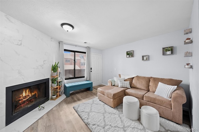 311 W Lehow Ave Unit 3, Englewood, CO 80110 - living area with visible vents, wood finished floors, and a high end fireplace