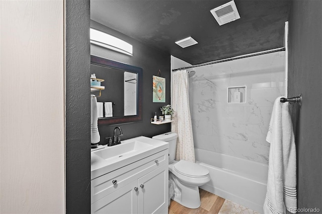 311 W Lehow Ave Unit 3, Englewood, CO 80110 - bathroom featuring toilet, visible vents, vanity, shower / bathtub combination with curtain, and wood finished floors