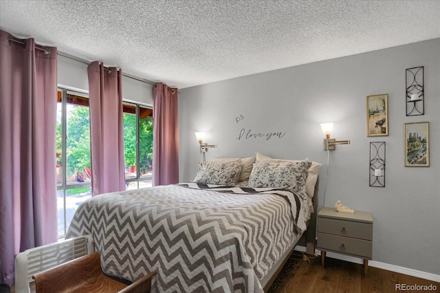 bedroom featuring access to outside, a textured ceiling, baseboards, and dark wood-style flooring