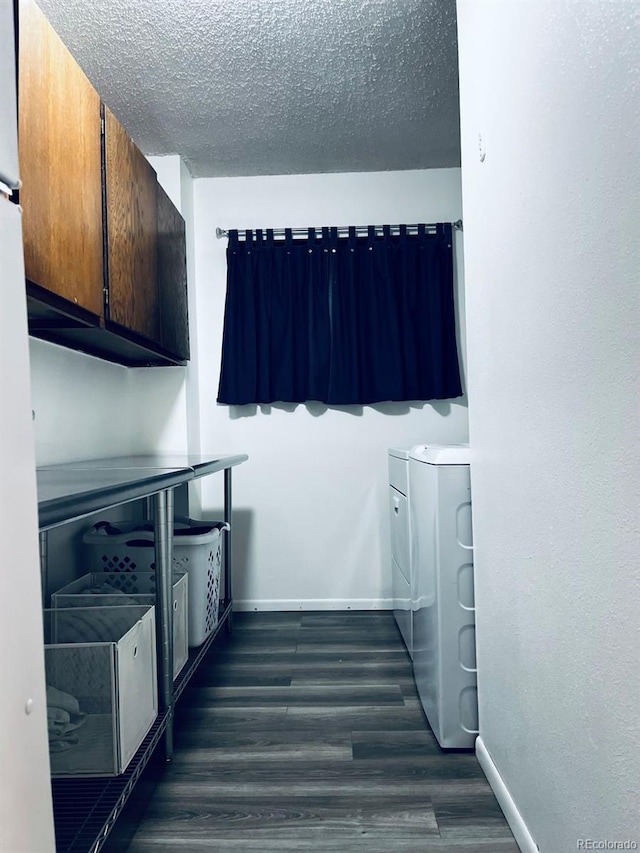 interior space featuring cabinet space, baseboards, separate washer and dryer, and dark wood finished floors