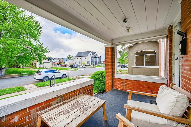 view of patio with covered porch and a residential view