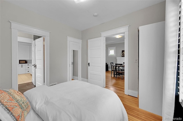 bedroom featuring light wood-type flooring and baseboards