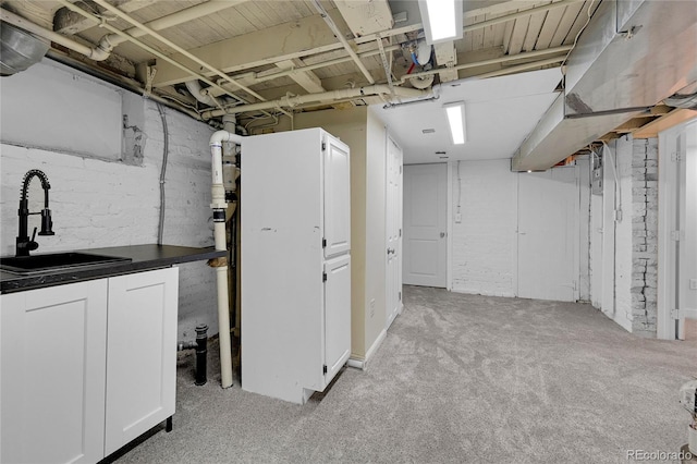 unfinished basement with light colored carpet and a sink