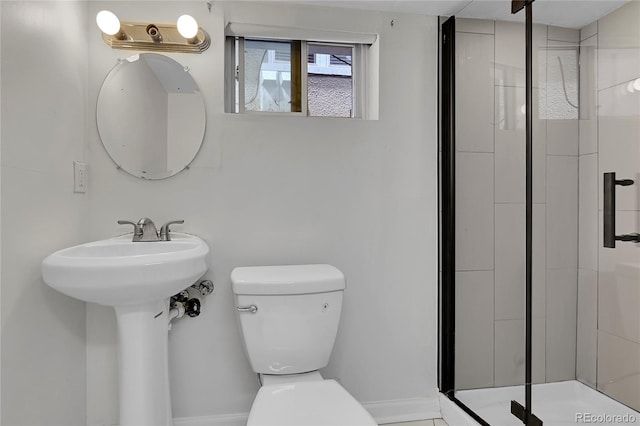 full bath featuring a sink, a shower stall, and toilet