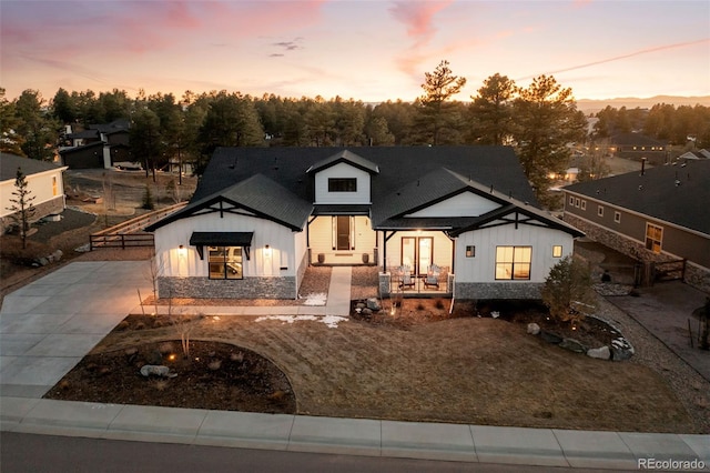 modern farmhouse style home with concrete driveway and board and batten siding