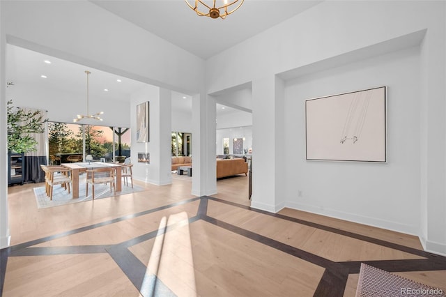 entryway featuring an inviting chandelier, wood finished floors, recessed lighting, and baseboards