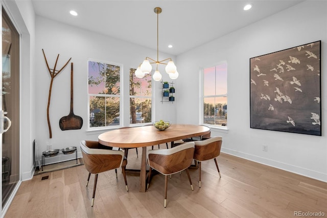 dining room featuring a notable chandelier, recessed lighting, light wood-type flooring, and baseboards