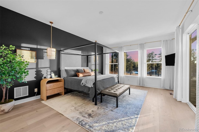 bedroom with visible vents and wood finished floors