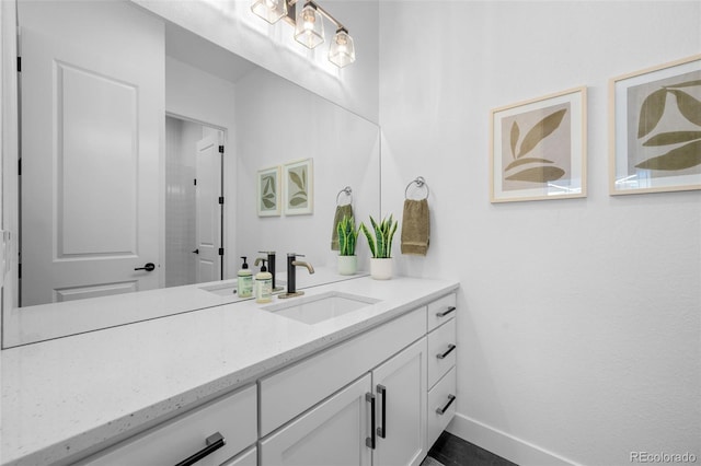 bathroom featuring vanity and baseboards