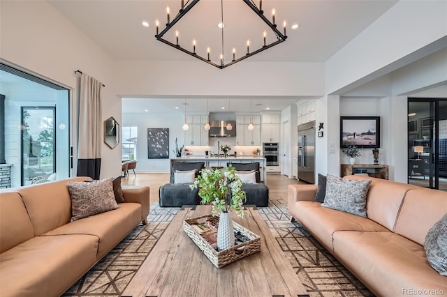 living room with an inviting chandelier and light wood finished floors