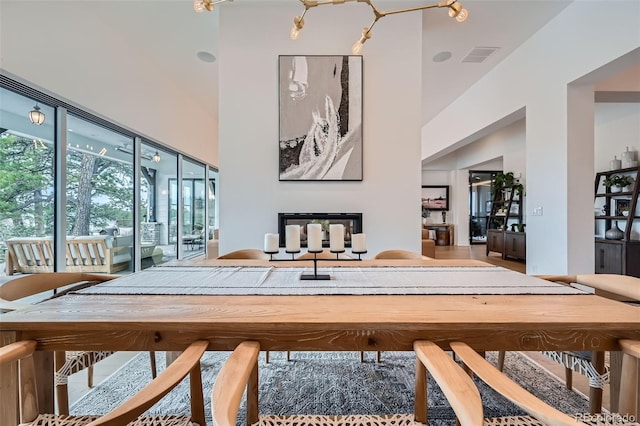 dining room with visible vents and a high ceiling