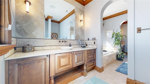 bathroom with vanity, ornamental molding, a washtub, and tile patterned floors