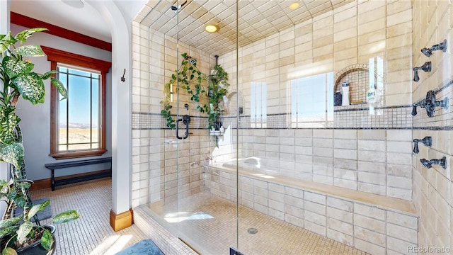 bathroom with tile patterned flooring and a shower with door