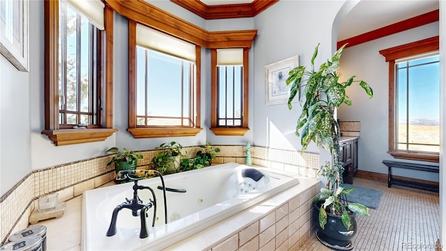 bathroom featuring a relaxing tiled tub, ornamental molding, and a wealth of natural light