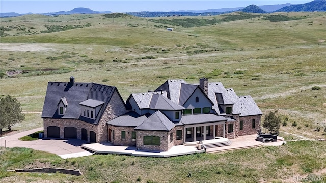 bird's eye view featuring a rural view and a mountain view