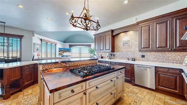 kitchen with pendant lighting, an inviting chandelier, appliances with stainless steel finishes, and a kitchen island