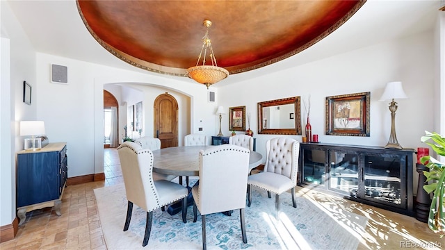 dining room featuring a raised ceiling