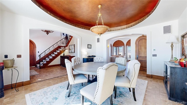 dining room with a raised ceiling