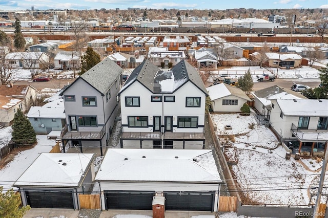 snowy aerial view with a residential view