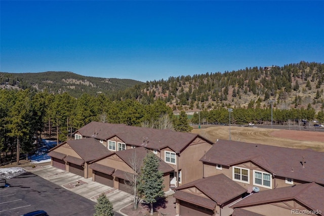 drone / aerial view with a mountain view and a wooded view