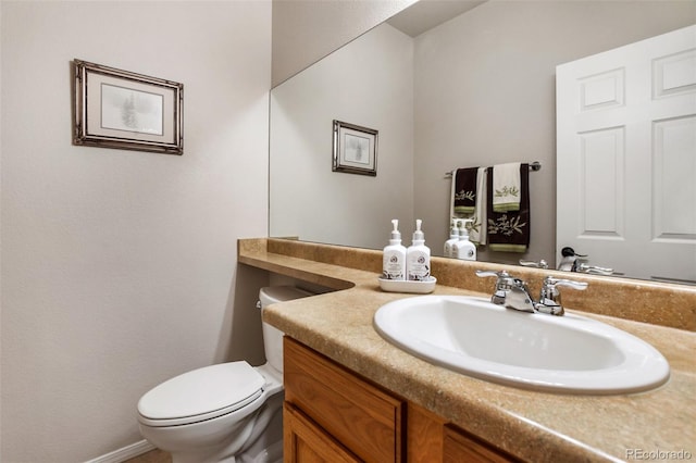 half bath featuring toilet and vanity