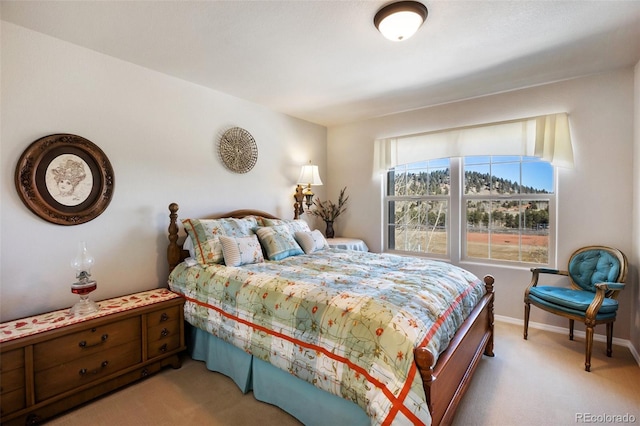 bedroom with baseboards and light carpet