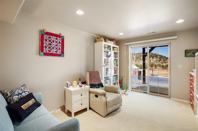 sitting room featuring light carpet, visible vents, recessed lighting, and baseboards