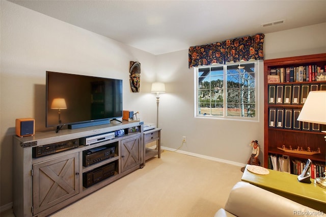 living area featuring light colored carpet, visible vents, and baseboards