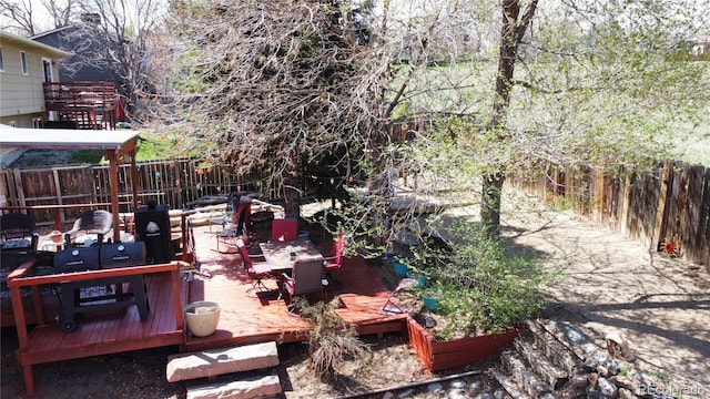view of yard featuring a fenced backyard and a wooden deck