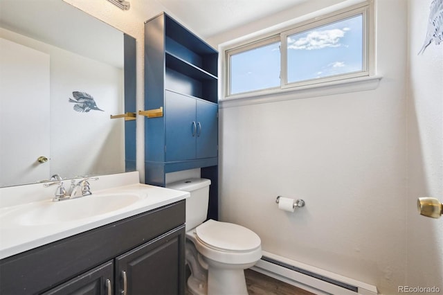 3660 S Ouray Cir, Aurora, CO 80013 - bathroom featuring a baseboard heating unit, vanity, and wood finished floors