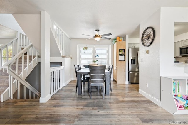 3660 S Ouray Cir, Aurora, CO 80013 - dining space with stairs, a ceiling fan, plenty of natural light, and light wood-type flooring