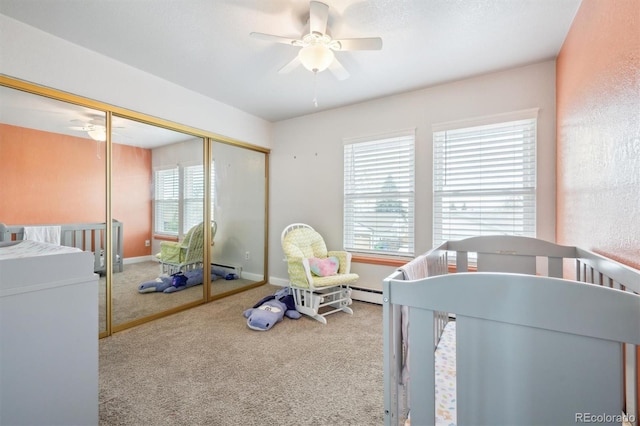 3660 S Ouray Cir, Aurora, CO 80013 - bedroom featuring carpet, a closet, a ceiling fan, and baseboard heating