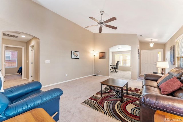 living room with ceiling fan, light carpet, and vaulted ceiling