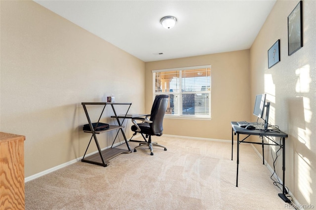 carpeted office space featuring baseboards