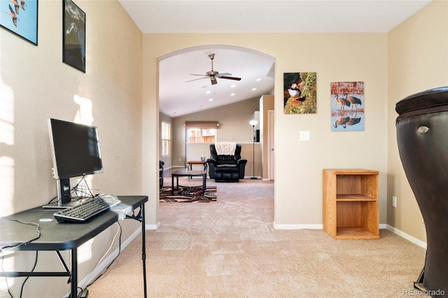 hall featuring arched walkways, baseboards, light carpet, and vaulted ceiling