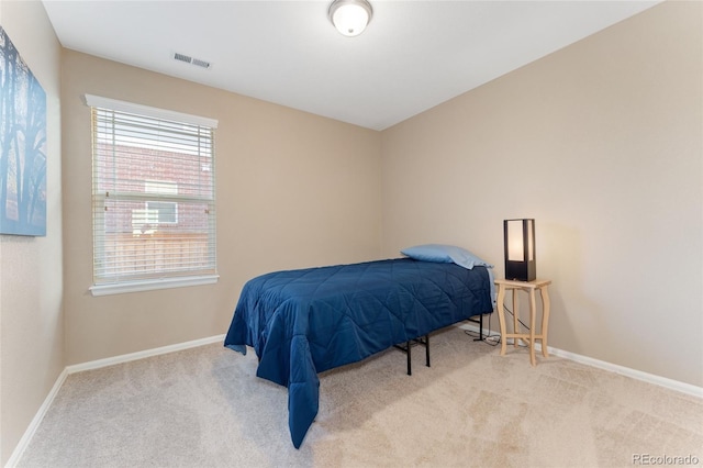 bedroom featuring baseboards, carpet flooring, and visible vents