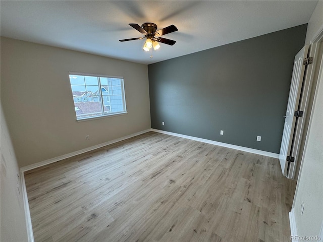 spare room featuring ceiling fan and light hardwood / wood-style flooring