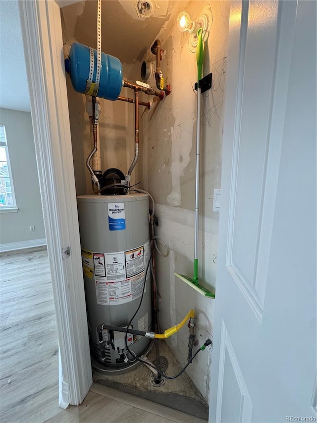 utility room featuring water heater