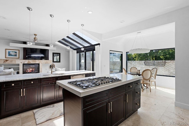 kitchen featuring sink, appliances with stainless steel finishes, a center island, and a healthy amount of sunlight