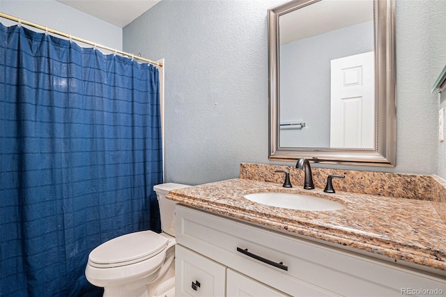 1566 S Syracuse St, Denver, CO 80231 - full bath featuring a textured wall, vanity, and a shower with curtain