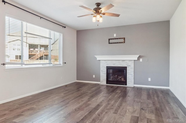 1457 Castle Creek Cir, Castle Rock, CO 80104 - unfurnished living room with a ceiling fan, wood finished floors, and a fireplace