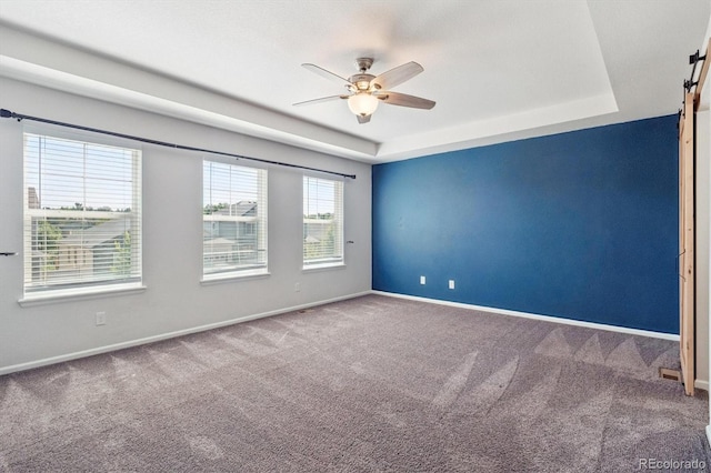 1457 Castle Creek Cir, Castle Rock, CO 80104 - carpeted empty room with a barn door, a ceiling fan, and a raised ceiling