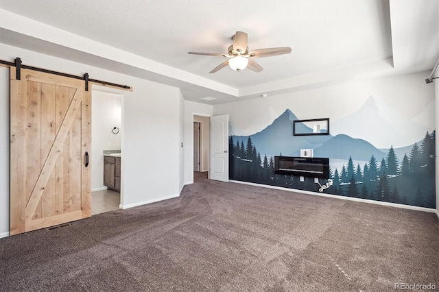 1457 Castle Creek Cir, Castle Rock, CO 80104 - carpeted living area featuring a barn door, a raised ceiling, and a ceiling fan