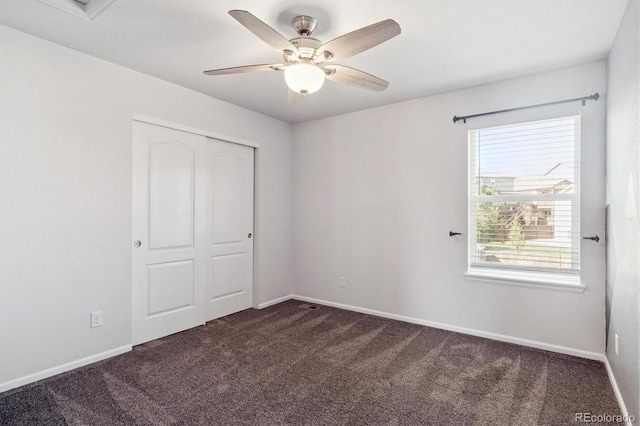 1457 Castle Creek Cir, Castle Rock, CO 80104 - unfurnished bedroom featuring dark carpet, a closet, and a ceiling fan