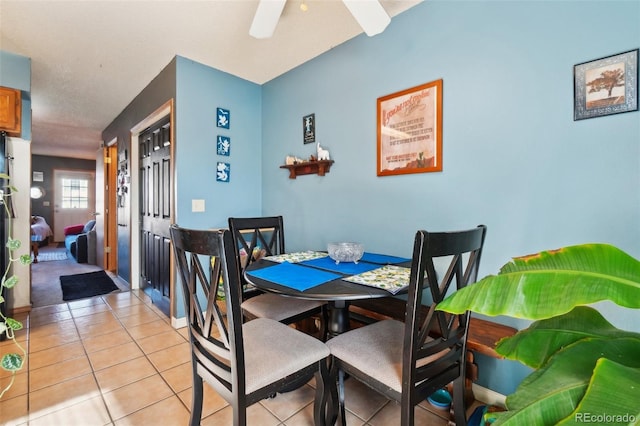 dining room featuring light tile patterned floors and ceiling fan