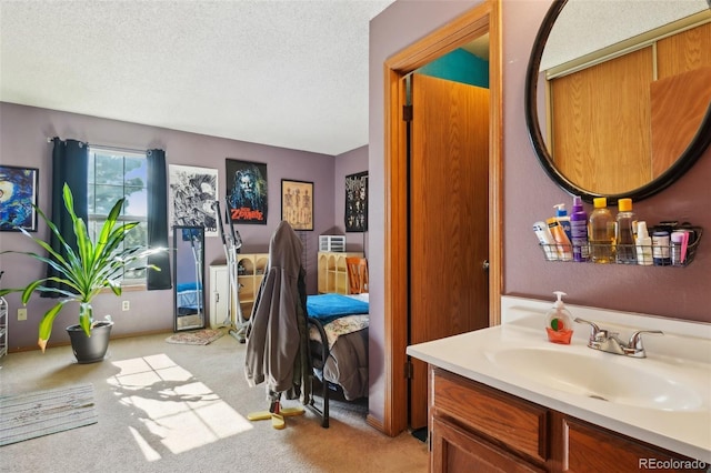 bathroom with a textured ceiling and vanity