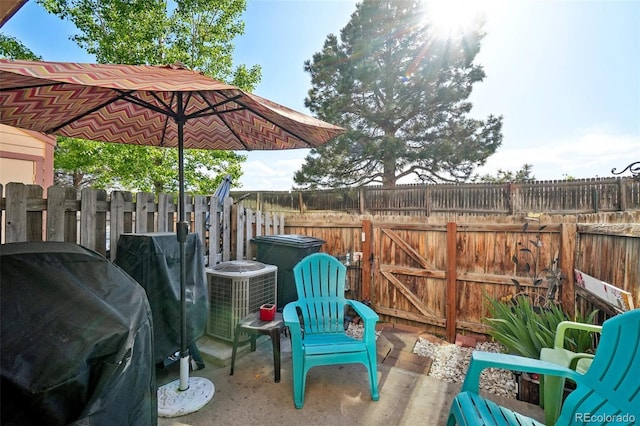 view of patio featuring grilling area, a fenced backyard, and cooling unit