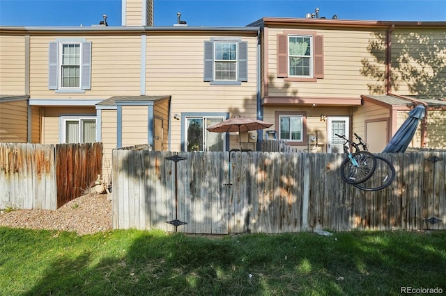 rear view of property featuring fence and a chimney