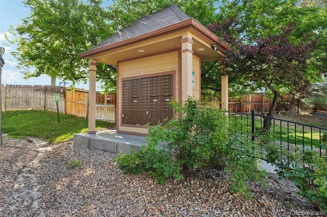 view of community featuring mail area and fence